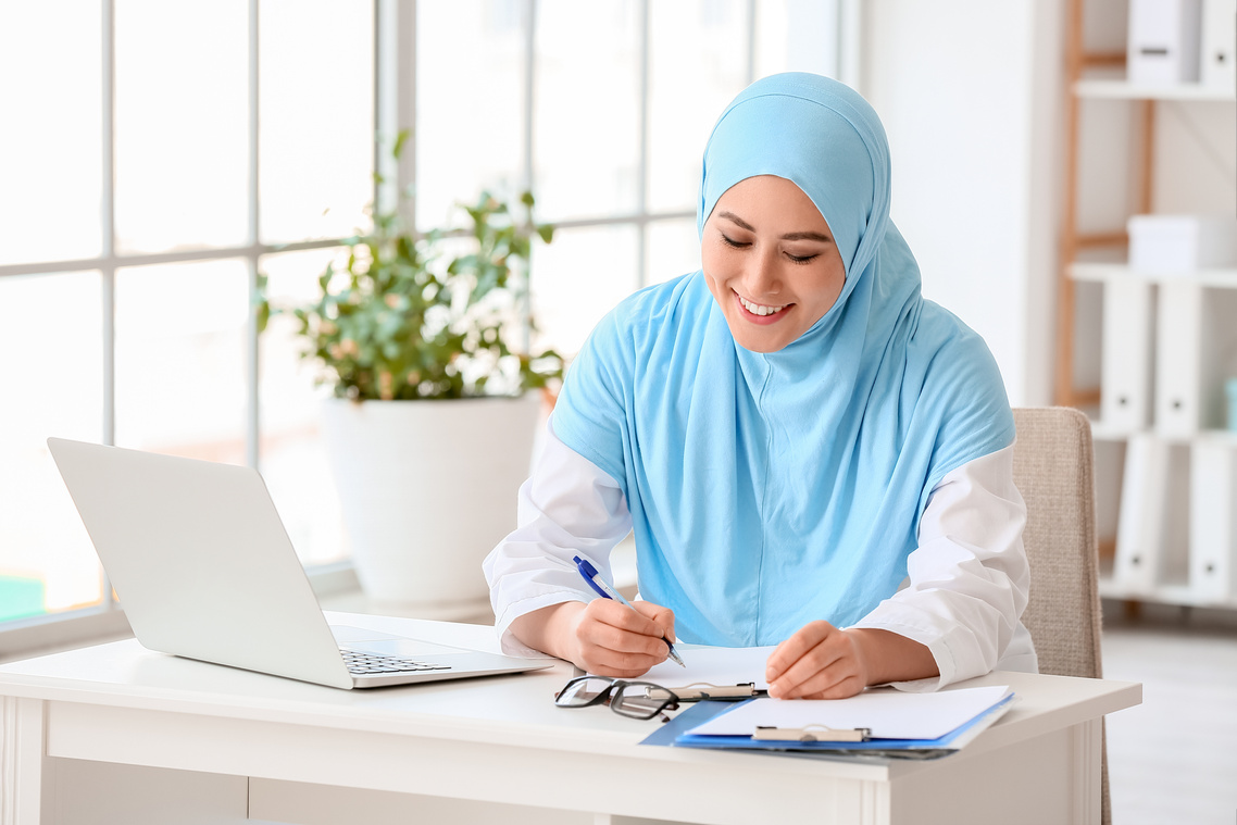 Muslim Female Doctor Working in Clinic